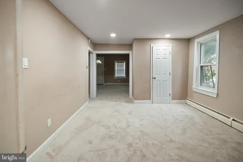 an empty room with windows and closet