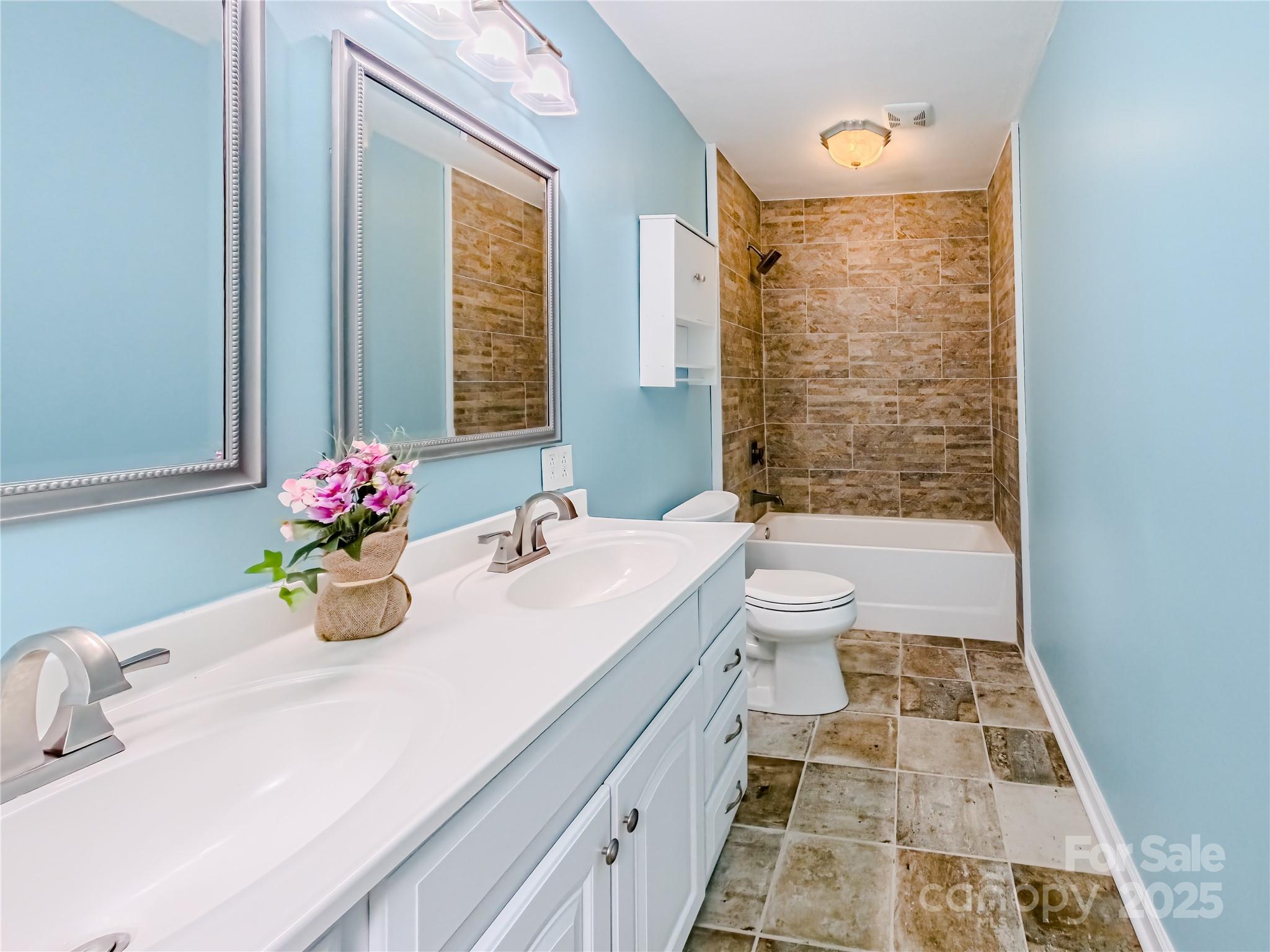 883 Pinehurst Road Ellenboro, NC 28040 - Photo 15 of 47 a bathroom with a double vanity sink toilet and shower