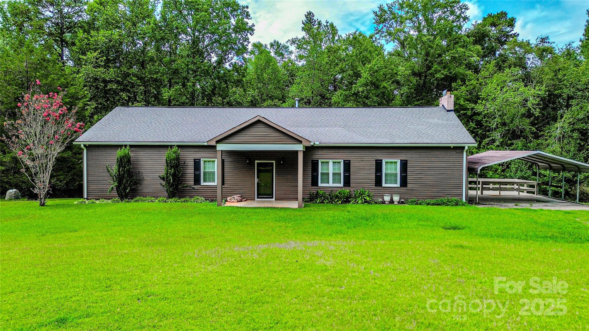 883 Pinehurst Road Ellenboro, NC 28040 - Photo 45 of 47 a front view of a house with a garden