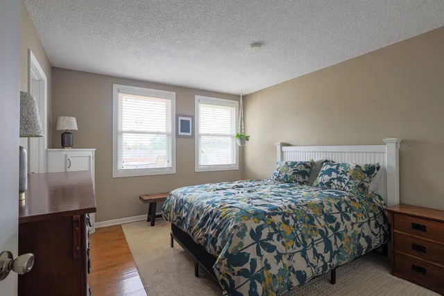 a bedroom with a bed and a night stand