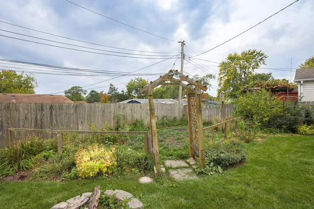 a view of a house with pool and chairs
