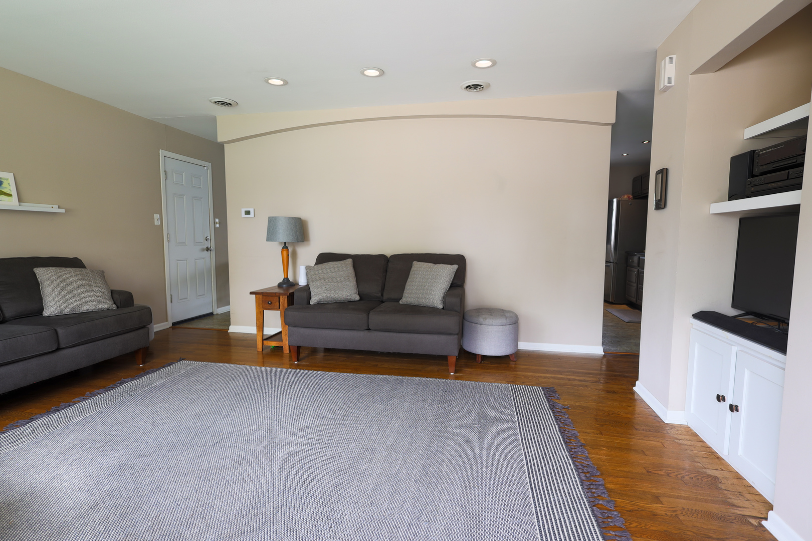 9425 Pine Street Mokena, IL 60448 - Photo 4 of 28 a living room with furniture and a flat screen tv