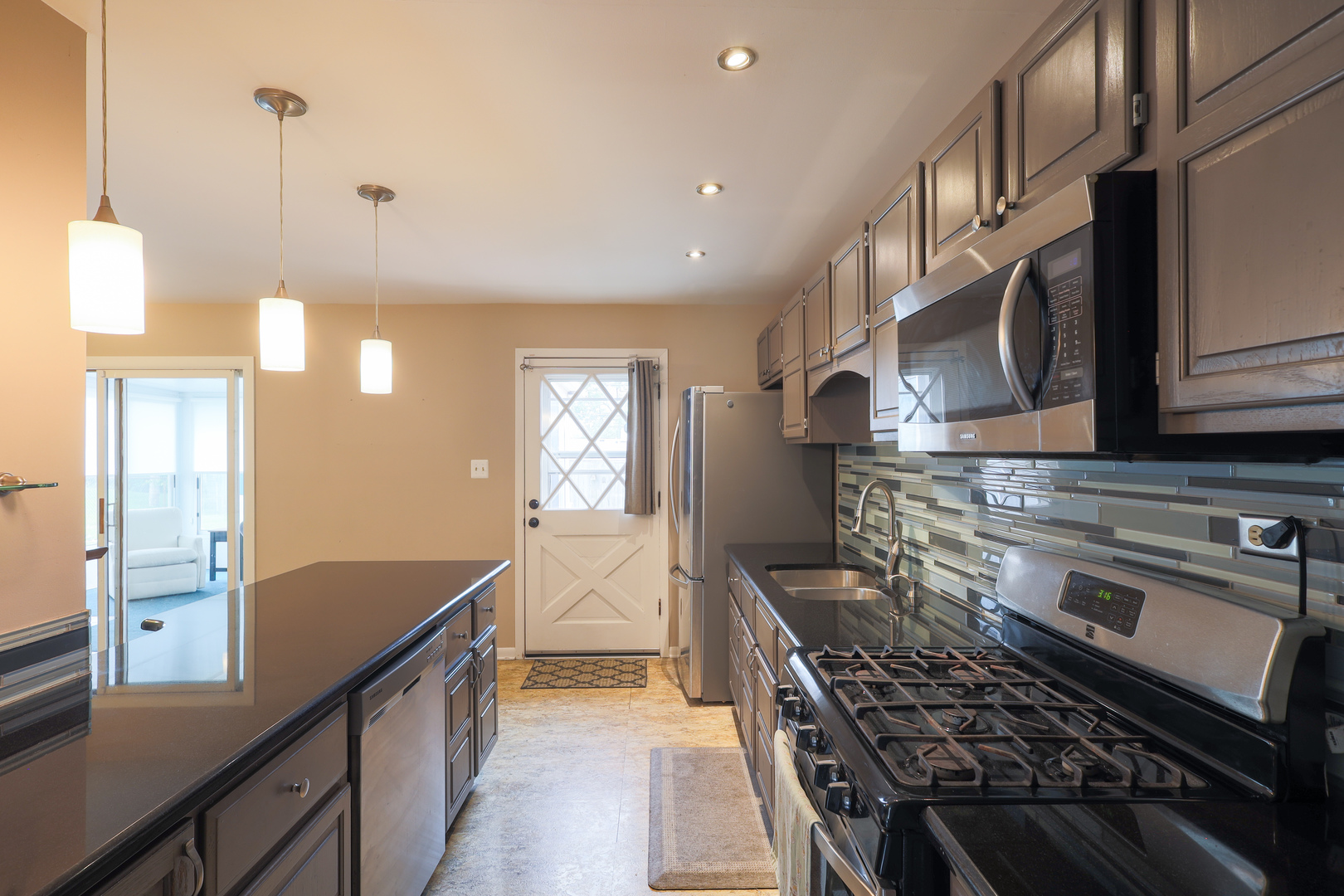 9425 Pine Street Mokena, IL 60448 - Photo 7 of 28 a kitchen with stainless steel appliances granite countertop a stove a sink and a microwave