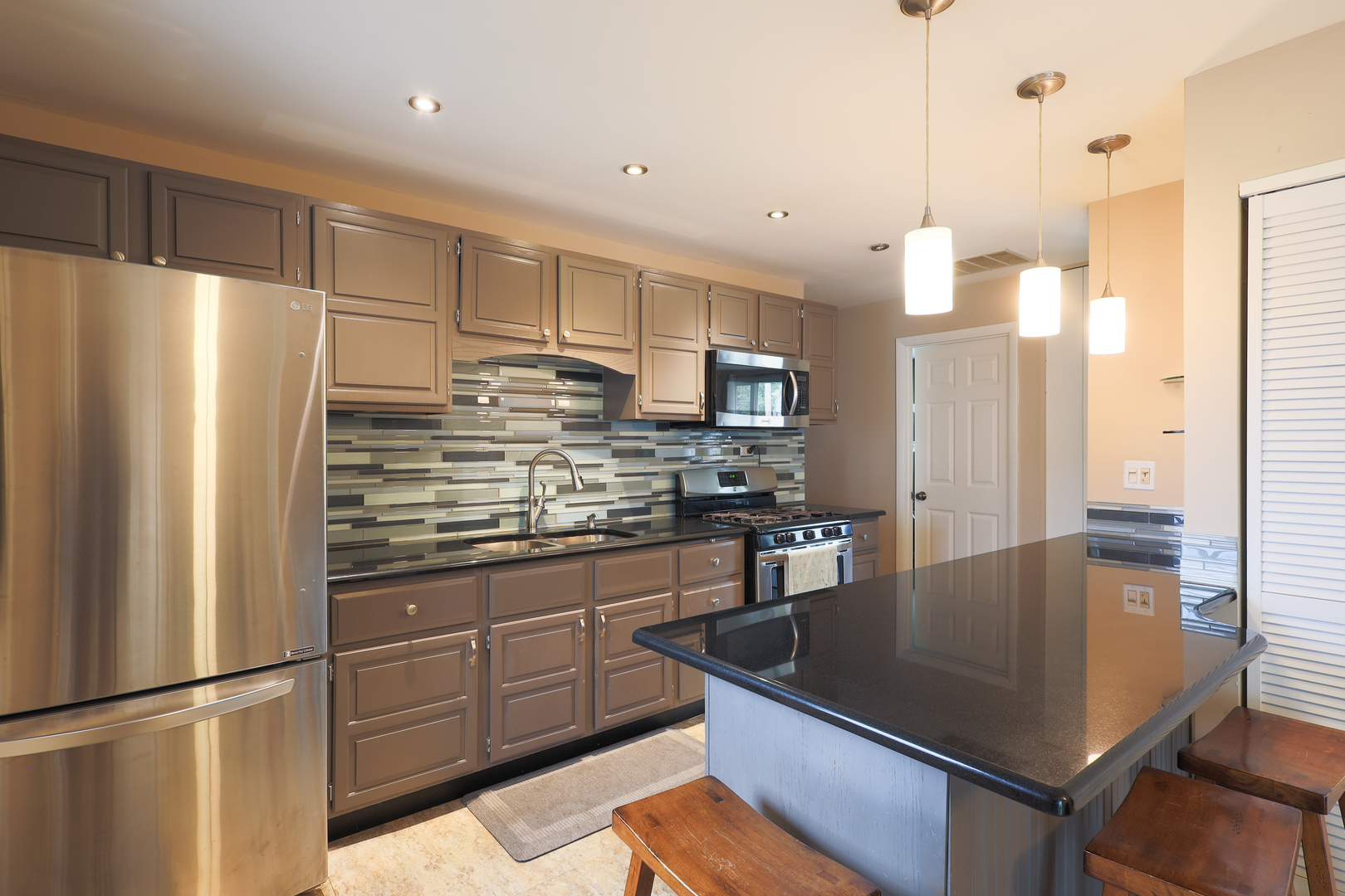 9425 Pine Street Mokena, IL 60448 - Photo 8 of 28 a kitchen with stainless steel appliances granite countertop a refrigerator a sink and a stove