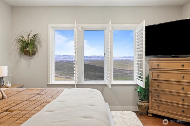 a bedroom with a bed and a flat tv screen