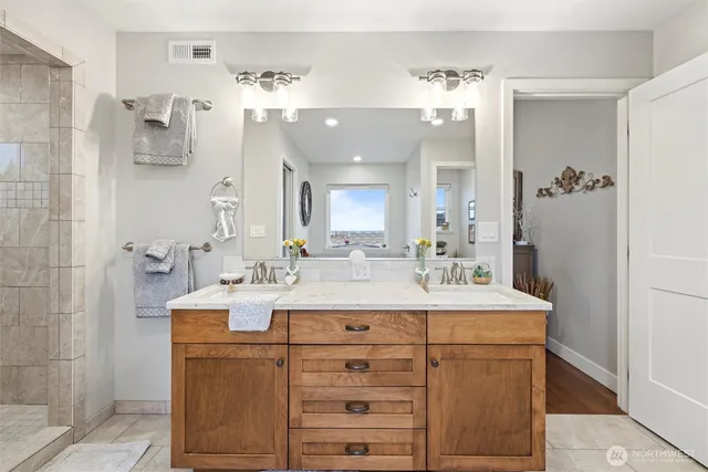 a bathroom with a sink vanity and a mirror