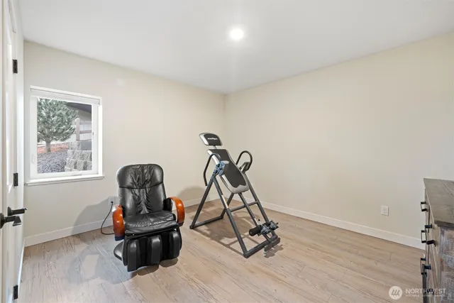 a living room with furniture and gym equipment