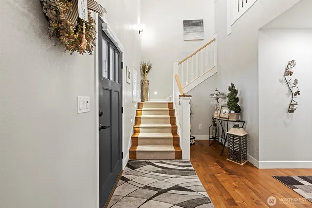 a view of entryway and hall with wooden floor