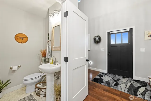 a bathroom with a toilet sink and mirror