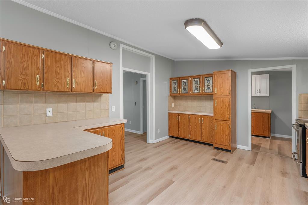 121 Kim Circle Stonewall, LA 71078 - Photo 15 of 33 a kitchen with stainless steel appliances granite countertop a sink a stove and a refrigerator
