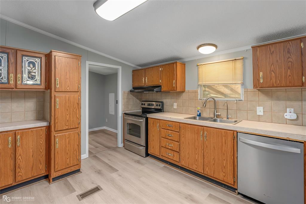 121 Kim Circle Stonewall, LA 71078 - Photo 16 of 33 a kitchen with stainless steel appliances granite countertop a refrigerator sink and cabinets