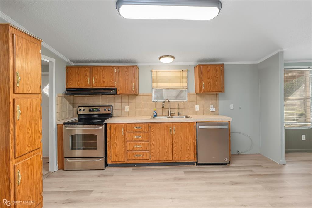 121 Kim Circle Stonewall, LA 71078 - Photo 19 of 33 a kitchen with stainless steel appliances a stove a sink and a microwave
