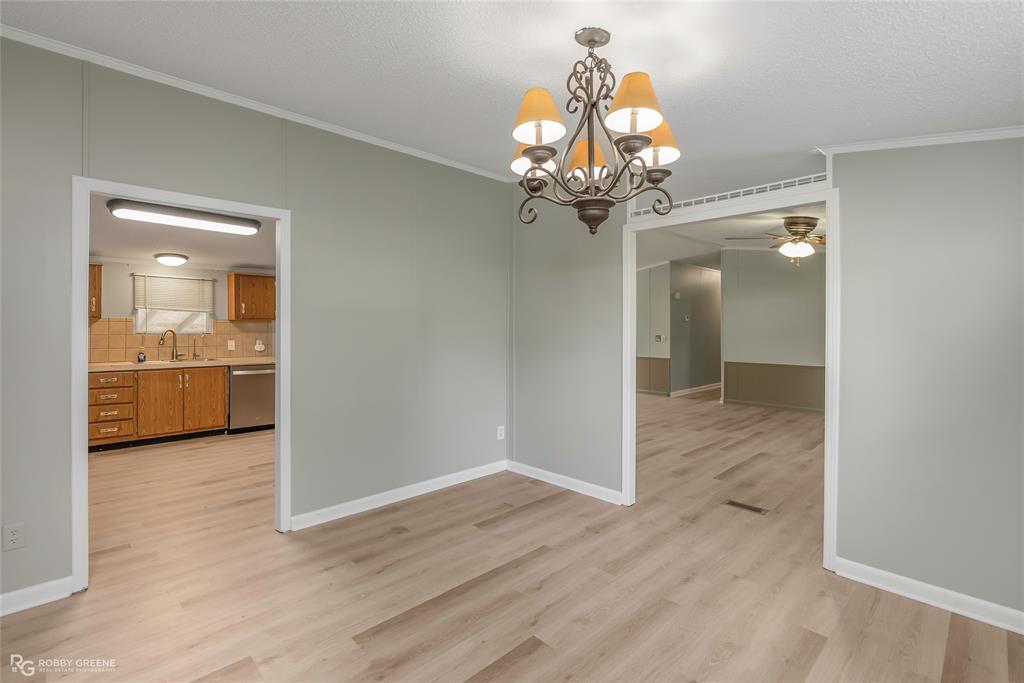 121 Kim Circle Stonewall, LA 71078 - Photo 21 of 33 a view of a hallway with wooden floor and a chandelier