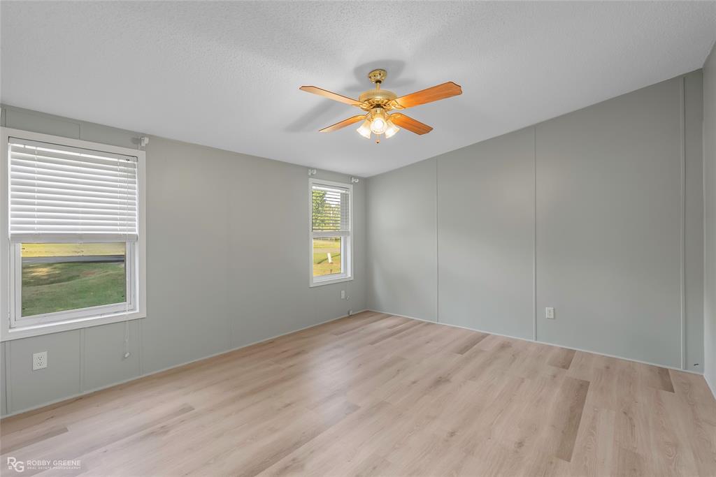 121 Kim Circle Stonewall, LA 71078 - Photo 23 of 33 wooden floor in an empty room with a window