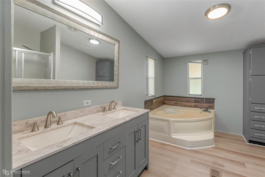 121 Kim Circle Stonewall, LA 71078 - Photo 25 of 33 a bathroom with a granite countertop sink and a mirror
