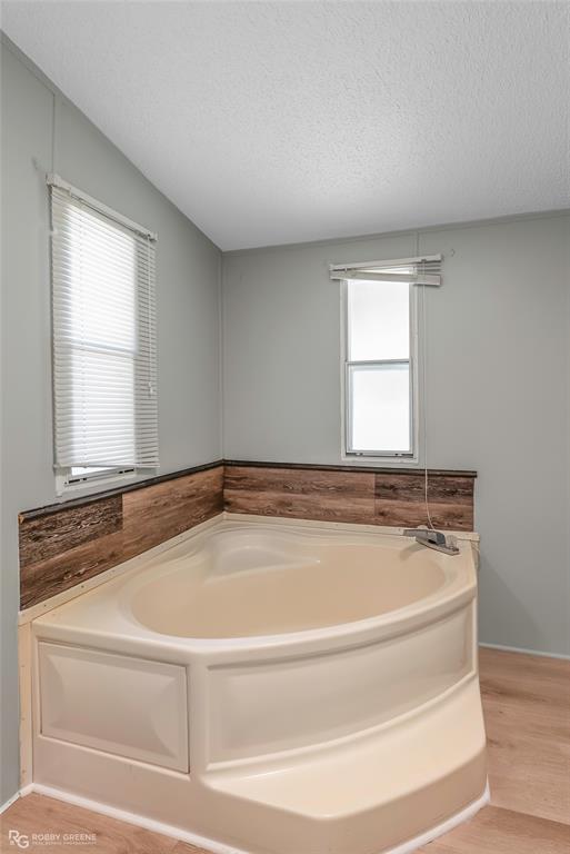 121 Kim Circle Stonewall, LA 71078 - Photo 27 of 33 a bath tub sitting in a bathroom next to a window