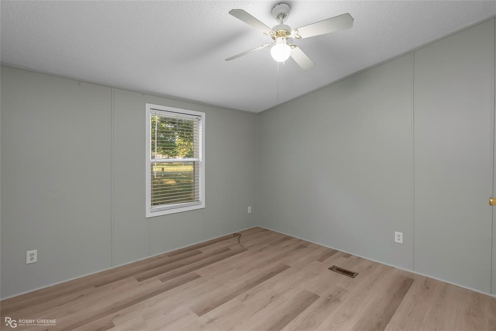 121 Kim Circle Stonewall, LA 71078 - Photo 28 of 33 an empty room with a window and ceiling fan