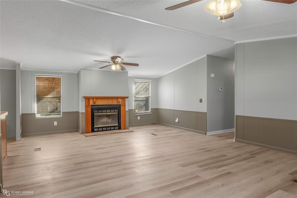 121 Kim Circle Stonewall, LA 71078 - Photo 10 of 33 an empty room with windows and fireplace