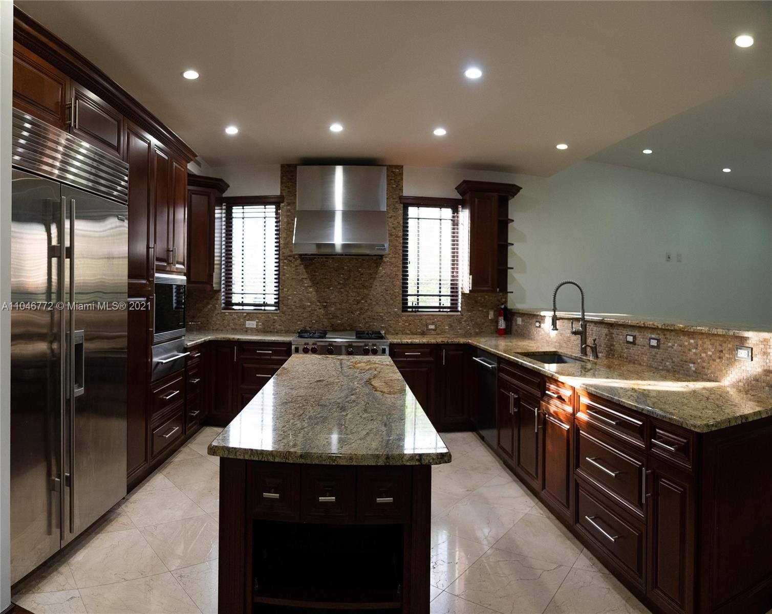 43 Southwest 20th Road Miami, FL 33129 - Photo 8 of 17 a kitchen with stainless steel appliances granite countertop a sink a stove and a refrigerator