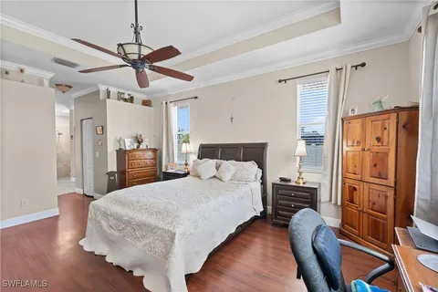 a bedroom with a bed and wooden floor