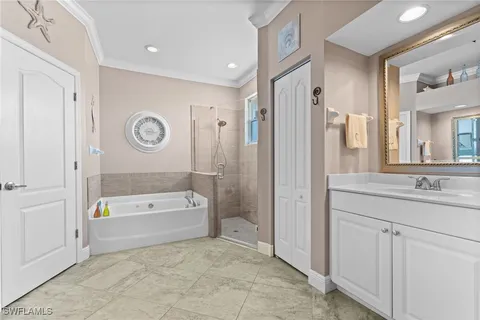 a spacious bathroom with a tub a sink and a large mirror