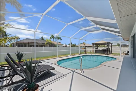 a view of a backyard with swimming pool