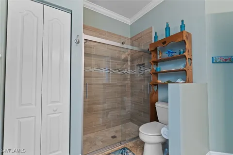 a bathroom with a toilet and shower