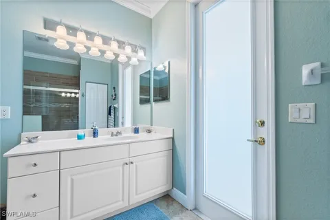 a bathroom with a double vanity sink and mirror