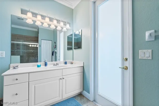 a bathroom with a double vanity sink and mirror