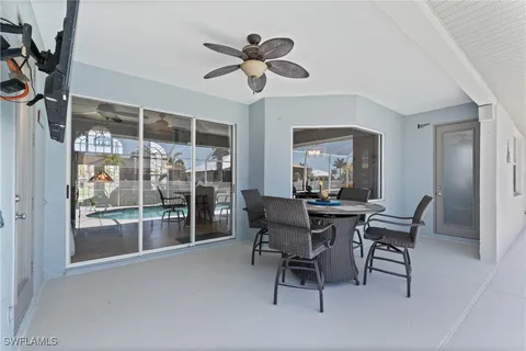 a view of a dining room with furniture and a chandelier fan
