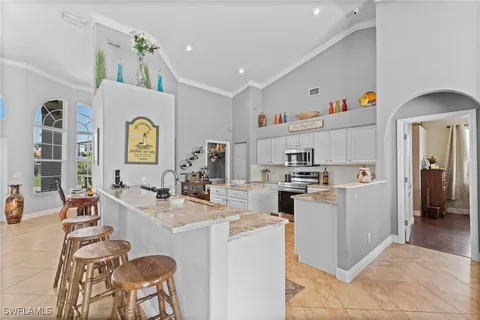 a kitchen that has a lot of cabinets a sink and appliances in it