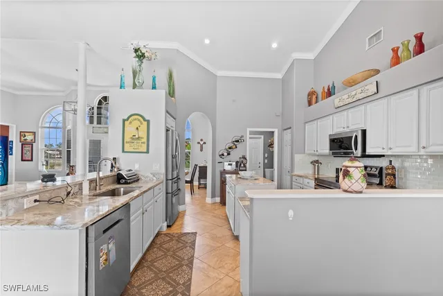 a large kitchen with stainless steel appliances lots of counter top space