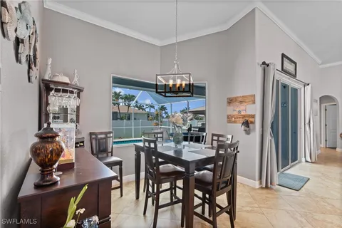 a view of a dining room with furniture and chandelier