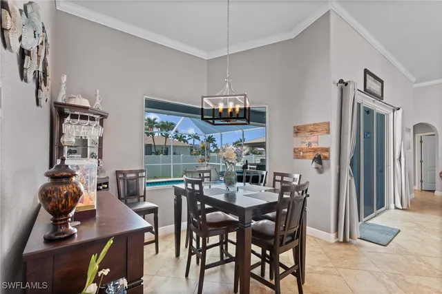 a view of a dining room with furniture and chandelier