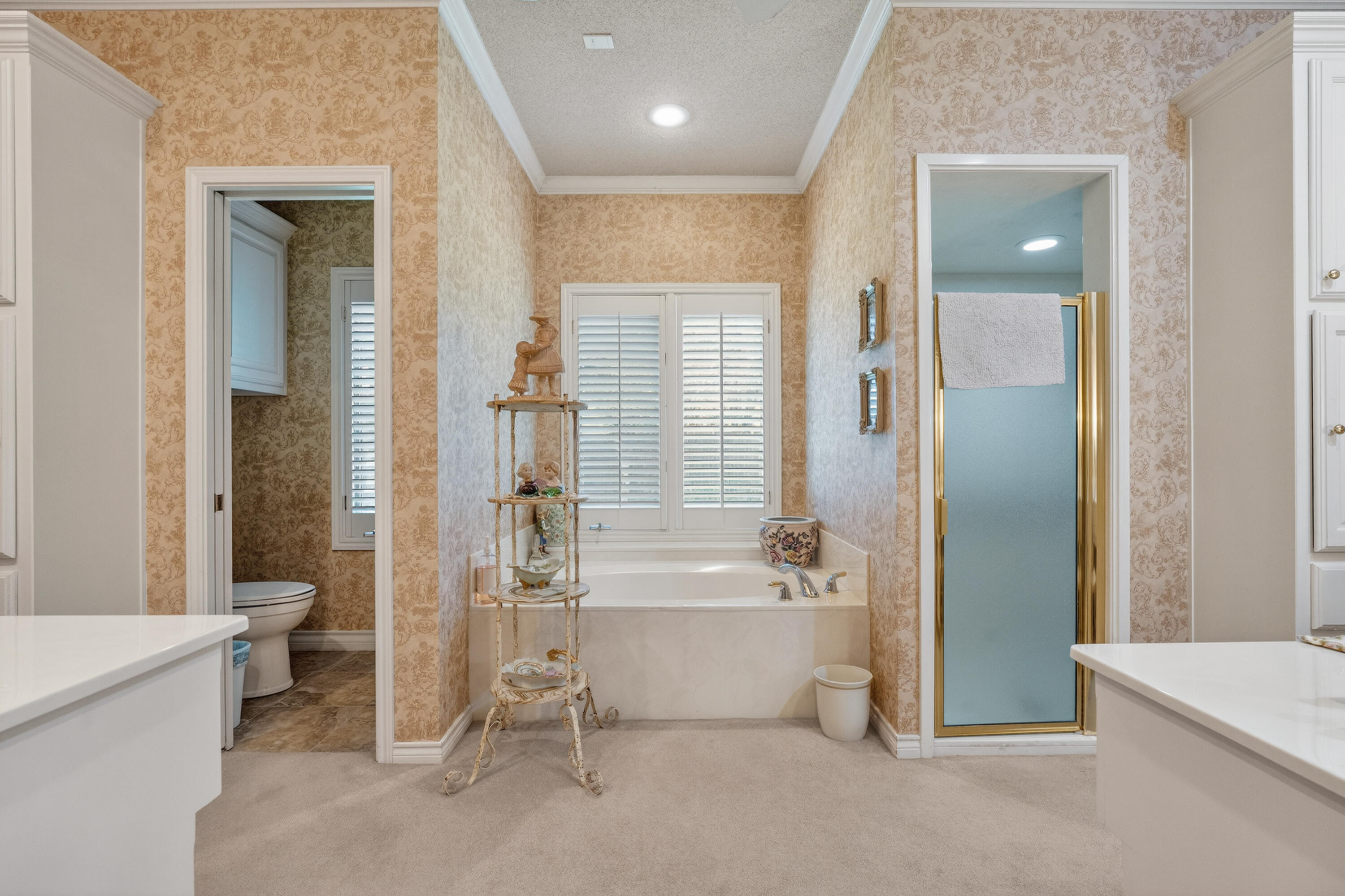 7402 95th Street Lubbock, TX 79424 - Photo 24 of 43 a bathroom with a bathtub and a toilet