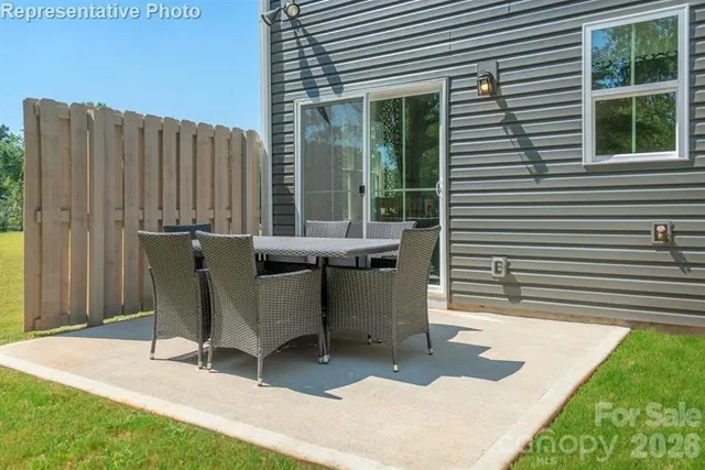 a view of a patio with table and chairs and wooden floor
