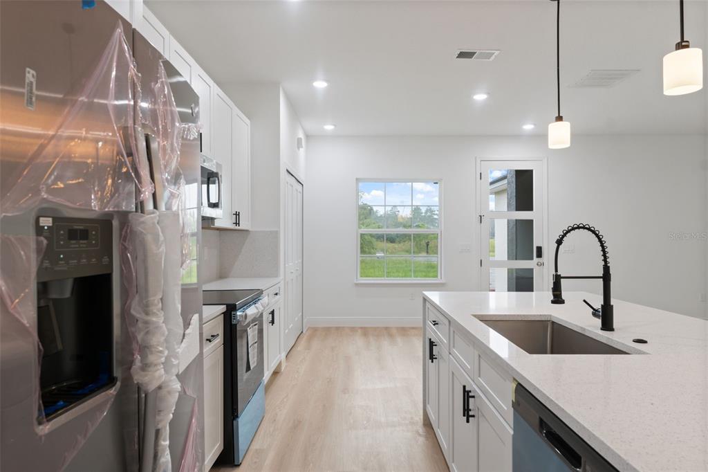 15775 Southwest 46th Circle Ocala, FL 34473 - Photo 13 of 35 a kitchen with a sink and a refrigerator
