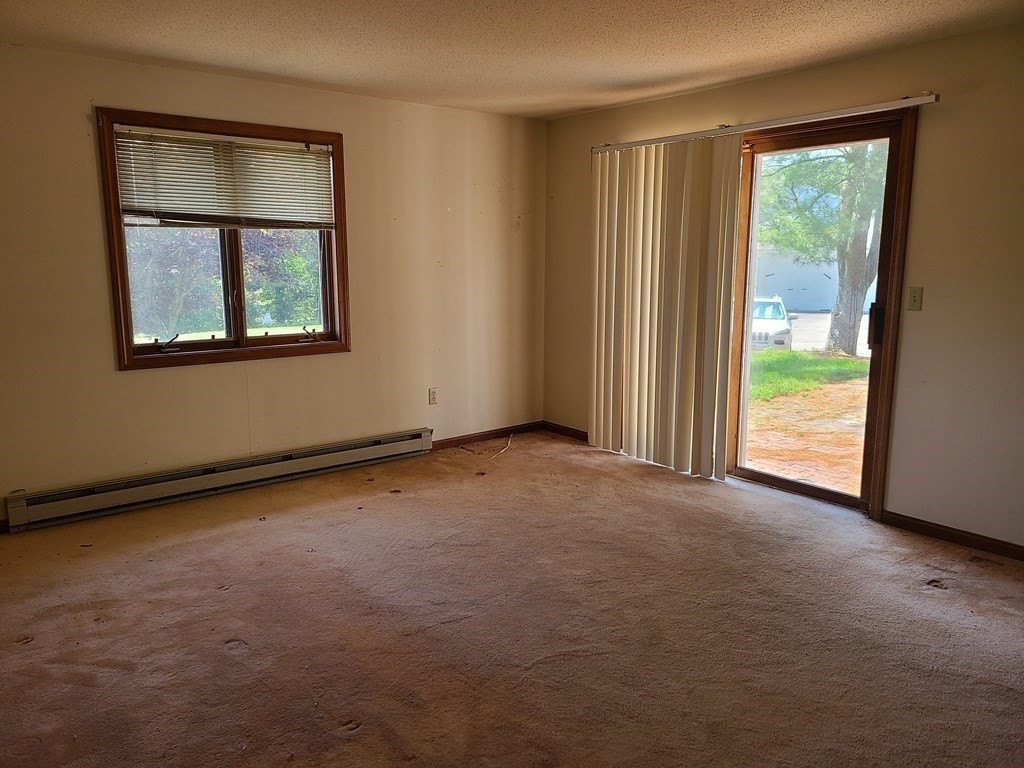 174 Lowell Road, Unit 62 Mashpee, MA 02649 - Photo 19 of 30 an empty room with windows and closet