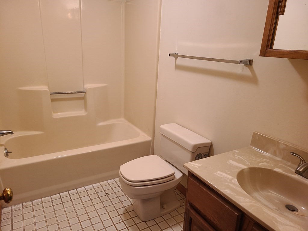 174 Lowell Road, Unit 62 Mashpee, MA 02649 - Photo 21 of 30 a bathroom with a sink toilet and shower