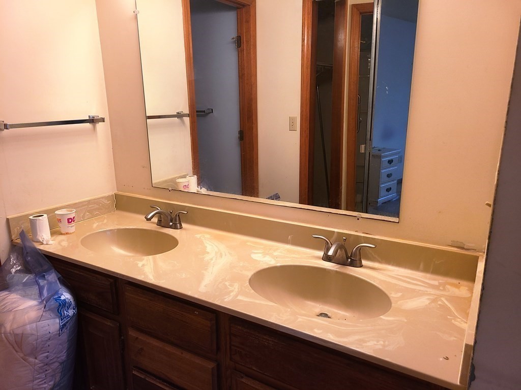 174 Lowell Road, Unit 62 Mashpee, MA 02649 - Photo 25 of 30 a bathroom with a sink and a mirror