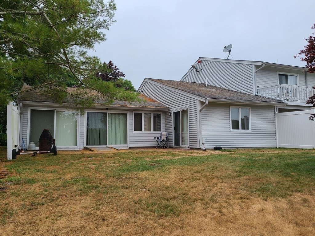 174 Lowell Road, Unit 62 Mashpee, MA 02649 - Photo 3 of 30 a front view of a house with a yard