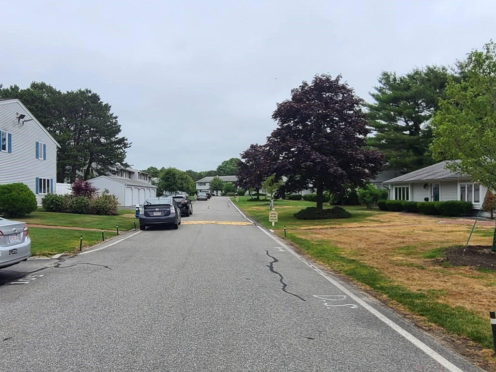 174 Lowell Road, Unit 62 Mashpee, MA 02649 - Photo 8 of 30 a view of a house with garden and tall trees