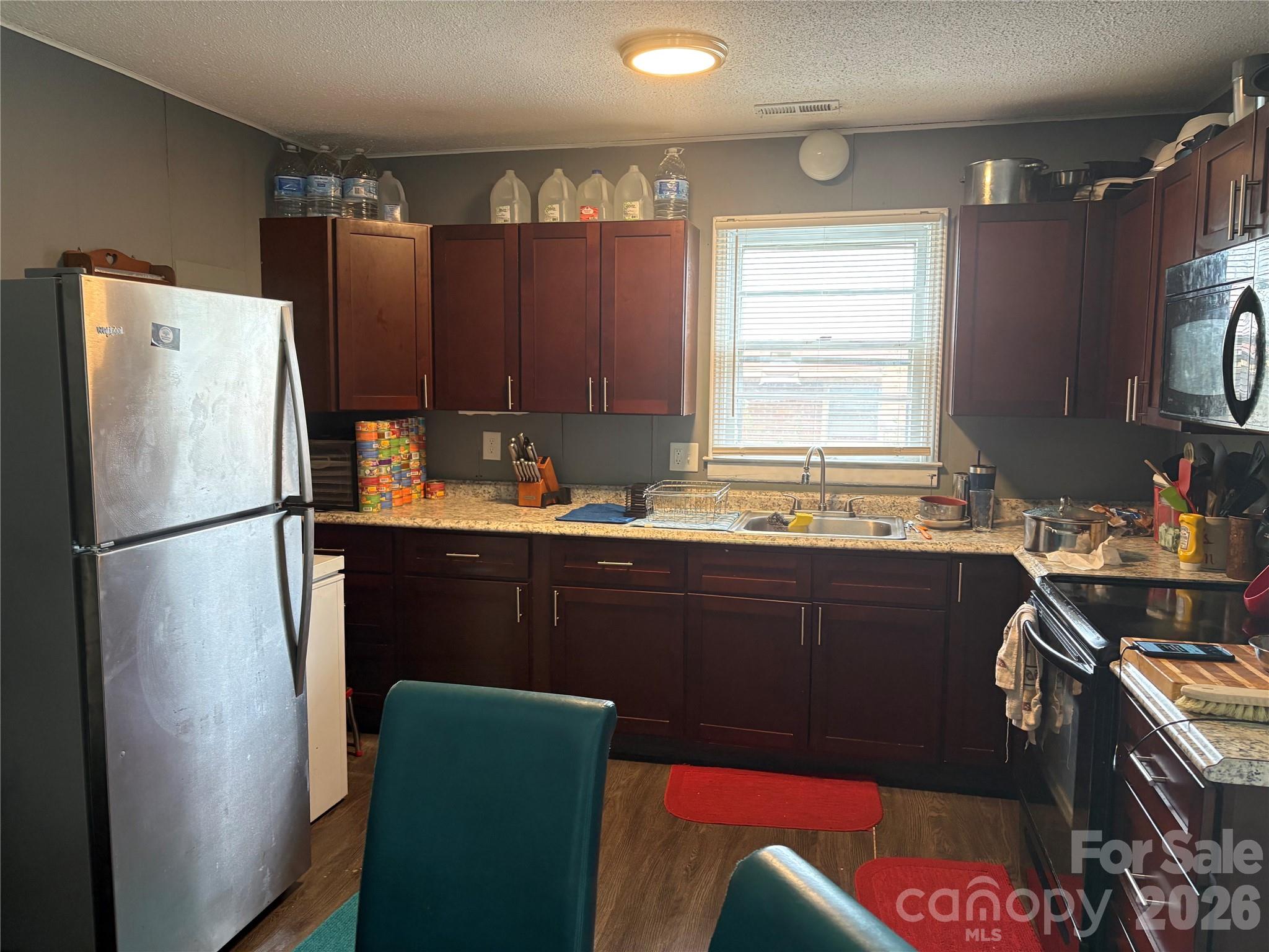 111 Magnolia Lane Lancaster, SC 29720 - Photo 3 of 8 a kitchen with stainless steel appliances granite countertop a refrigerator and a sink