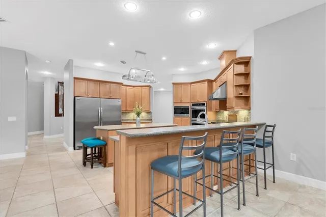 a spacious bedroom with a bed and a wooden floor