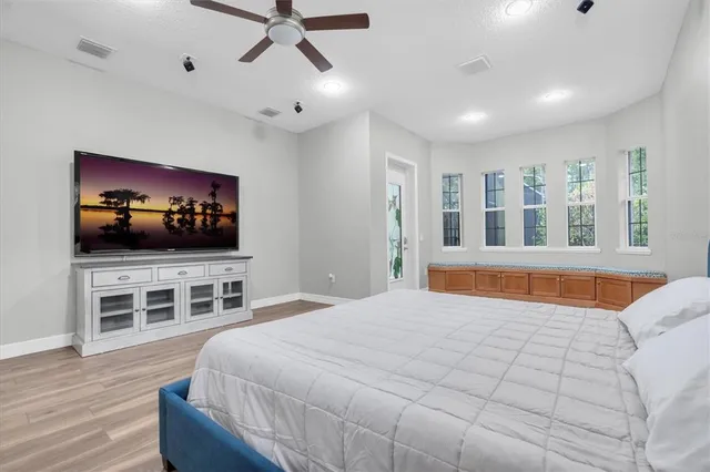 a bathroom with a shower a sink and a large mirror
