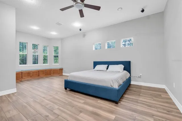 a bathroom with a granite countertop sink and a toilet
