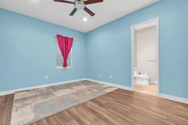 a view of a patio with table and chairs potted plants with wooden fence