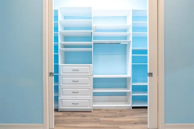 a view of backyard with wooden fence and a large tree