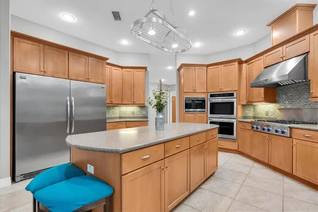 a kitchen with stainless steel appliances granite countertop a sink and cabinets