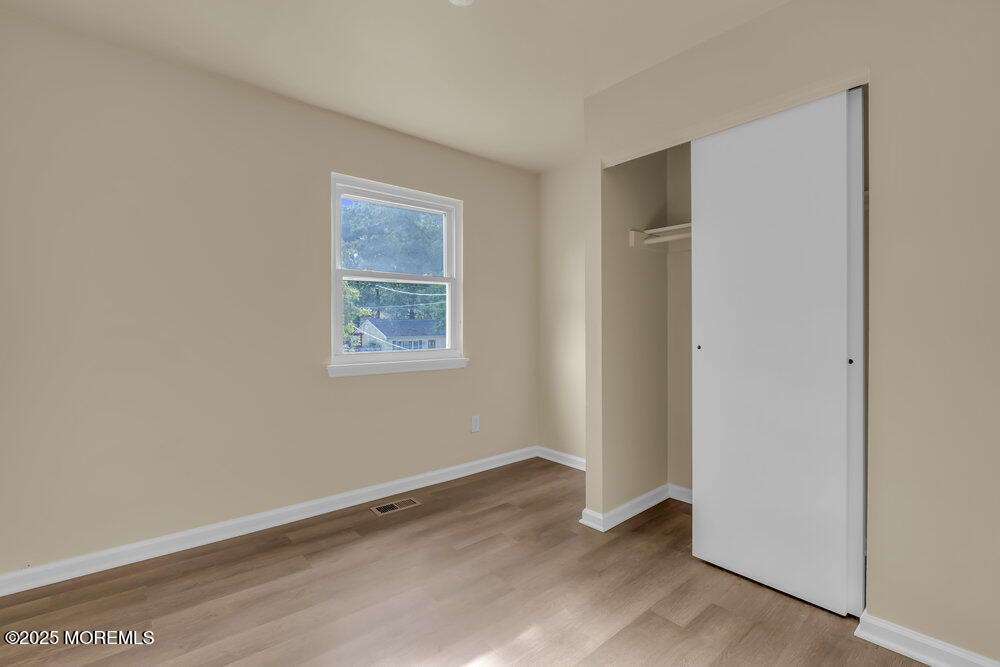 32 Pine Tree Drive Bayville, NJ 08721 - Photo 11 of 63 a view of an empty room with a window